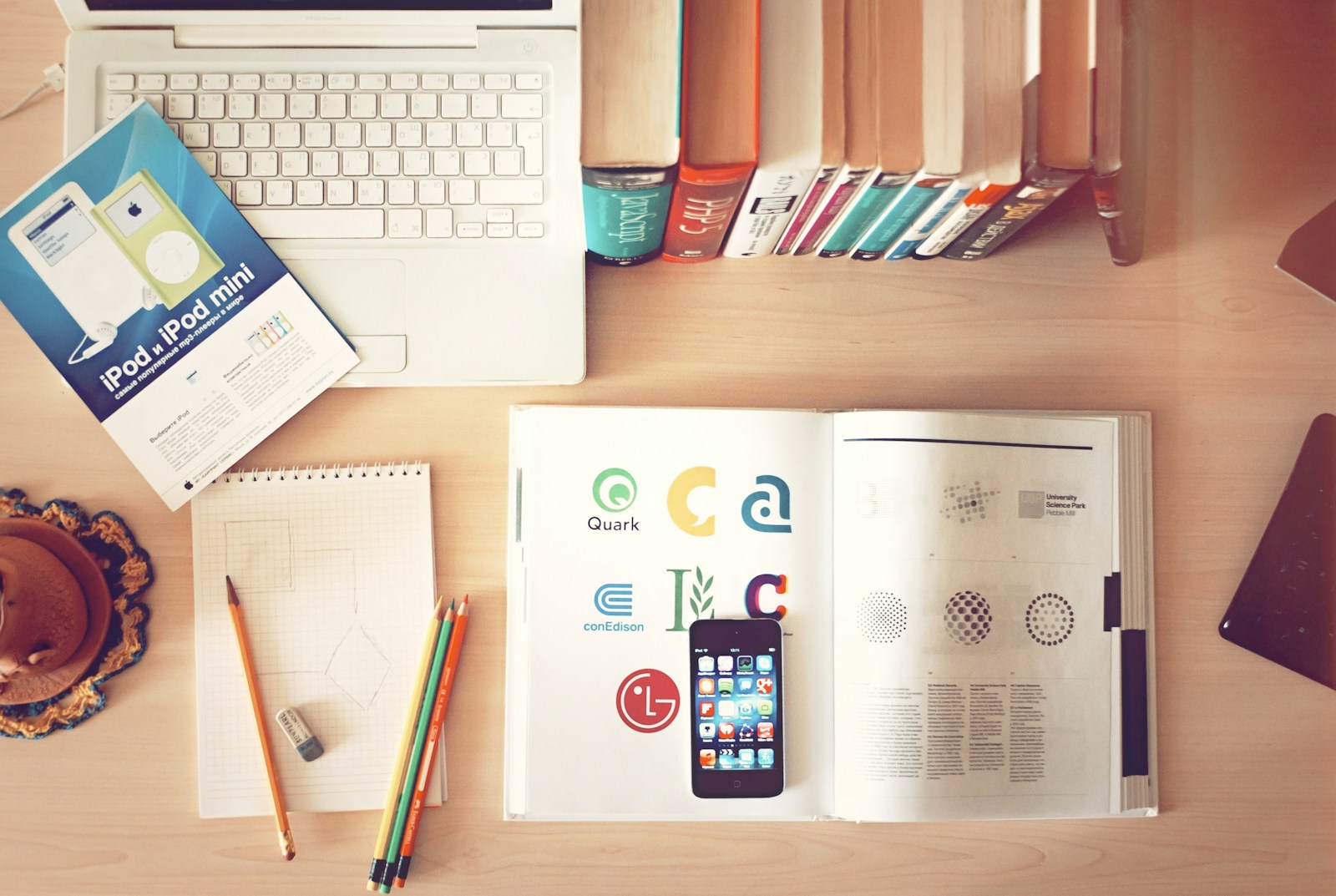 pencils and smartphone on top of books